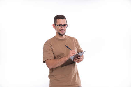 Man Writing in Clipboard Smilling Isolated. Man Working with Clipboard. Commecial, Shopping, Advertisment Conceptの写真素材