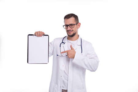 Doctor Man Showing Blank Clipboard Pointing at it Isolated. Advertisment, Office, Commercial Conceptの写真素材
