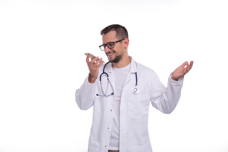 Doctor Talking on Phone Standing Isolated. Doctor Smiling. Commecial, Medicine, Advertisment Concept. Technologyの写真素材