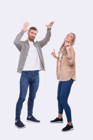 Young Couple Making High Five Standing Isolated. Signの写真素材