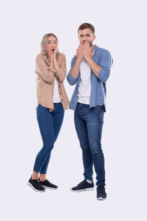 Couple Standing Surprised, Amazed, Shocked. Couple Holding Hands near Face Isolated.の写真素材