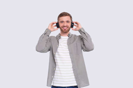 Man Listening to Music Enjoying It. Man Listening Music with wireless headphones Isolatedの写真素材