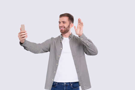 Man Having Video Call on Phone Waving Isolated. Man Video Call. Man Using Phone.の写真素材