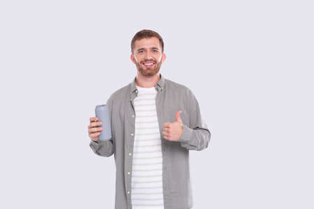 Man Holding Tin Can Showing Thumb Up. Man With Beer Bottle in Hands. Alcohol Drink Canの写真素材