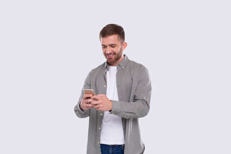 Man Standing Using Phone Isolated. Man Texting on Phone. Technologyの写真素材