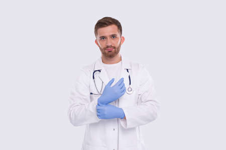 Doctor Puts on Gloves Isolated. Man Doctor Protection Workwear. Medical Concept Corona Virus. Glovesの写真素材