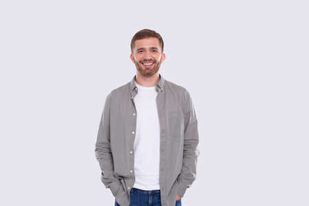 Man Standing Isolated Smilling Hands in Pocketsの写真素材