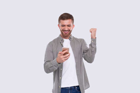 Man Excited Winning. Man Holding Phone. Winner. Man Won online Casino, Lotteryの写真素材