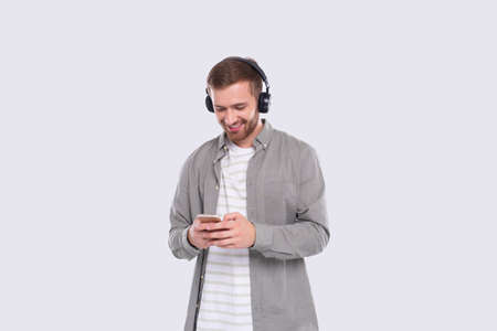 Man Listening to Music from Phone Chatting. Man Holding Phone. Isolatedの写真素材