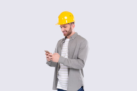 Construction Worker Standing Using Phone Isolated. Man Texting on Phone. Technology Isolated