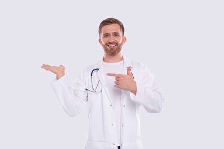 Doctor Showing Hand to Side Pointing at It. Medical Worker. Gesture Concept Isolatedの写真素材