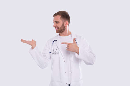 Doctor Showing Hand to Side Pointing at It Looking at It. Medical Worker. Gesture Concept Isolatedの写真素材