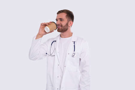 Doctor Holding Coffee in To Go Cup. Man With Take Away Coffee Cup. Coffee Drink. Man Doctor Isolatedの写真素材