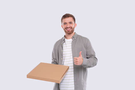 Man Holding Pizza Box Showing thumb Up Isolated. Fast Food, Unhealthy food Concept Isolatedの写真素材