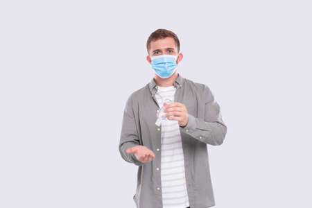 Man Using Hands Antiseptic Wearing Medical Mask Isolated. Hands sanitizerの写真素材