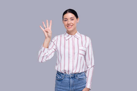 Girl Showing Four Fingers. Girl Showing Number Three. Isolatedの写真素材