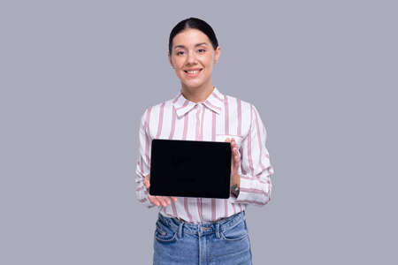 Girl Showing Tablet Standing Isolated. Commecial, Shopping, Advertisment Concept Isolatedの写真素材