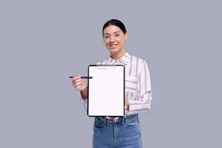 Office Girl Showing Blank Clipboard Isolated. Advertisment, Office, Commercial Conceptの写真素材