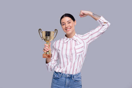 Girl Holding Trophy Happy Isolated. Girl Goals. Winner. Girl Smilling. Trophy in Girl Handsの写真素材