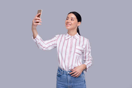 Girl Having Video Call on Phone Isolated. Girl Video Call. Girl Using Phone. Isolatedの写真素材