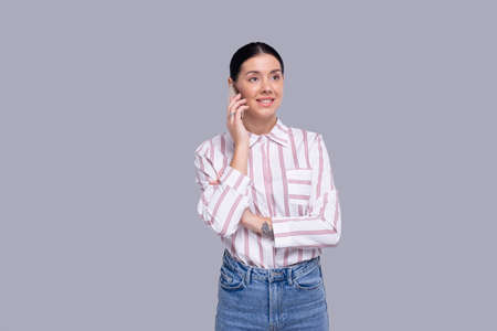 Girl Talking on Phone Standing Isolated. Commecial, Shopping, Advertisment Conceptの写真素材