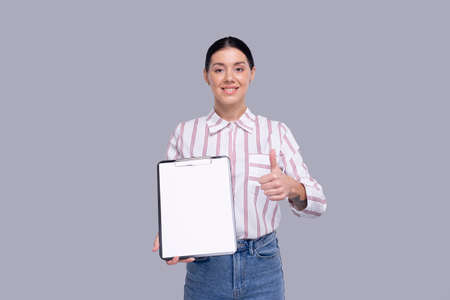 Office Girl Showing Blank Clipboard Showing Thumb Up Isolated. Advertisment, Office, Commercial Conceptの写真素材