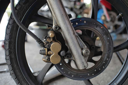 Oil-stained disc brakes on the front wheels of a motorbikeの写真素材