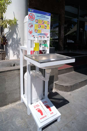 Semarang, Indonesia,19/09/2020. A place to wash hands for visitors, complete with soap and a rinsing tap that is placed before entering hotel lobby has become standard health protocol during Covid-19のeditorial素材