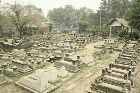 Yogyakarta, Indonesia, Feb 15, 2014. The public cemetery complex is covered in volcanic ash...
