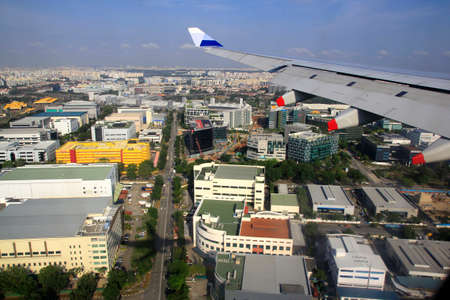 Singapore, Feb 23, 2015. Singapore's bustling commercial, office and apartment center building seen from aircraft approaching landing at Changi international airportのeditorial素材