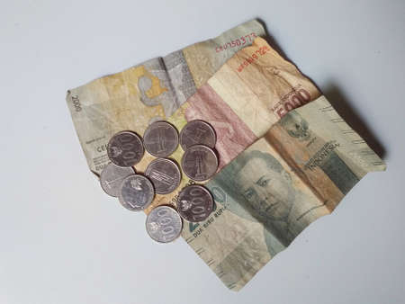 Klaten, Indonesia, Jan 25, 2021. Currency worth 5000 rupiah, 2000 rupiah and 1000 rupiah coins officially issued by Bank Indonesia and used as a transaction tool in a shabby and disheveled state.のeditorial素材