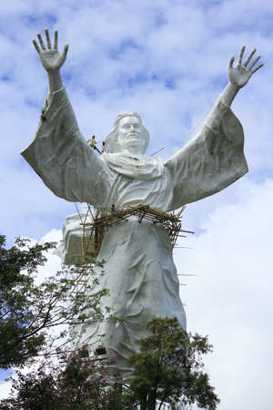 Manado, Indonesia, June 17, 2015. Workers take care of one of Manado's popular landmarks, the giant Jesus Blessing statue.のeditorial素材