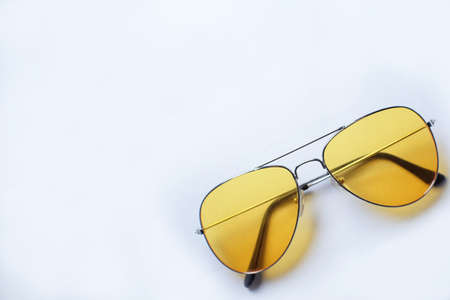 Classic glasses with yellow filter glass on a white backgroundの写真素材