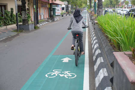 Klaten, Indonesia, Feb 14, 2021. Special lane markings for cyclists crossing the middle of an urban roadのeditorial素材
