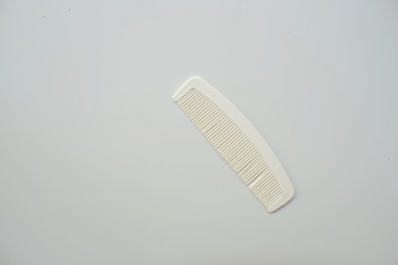 Small white comb for mobility isolated on whiteの写真素材