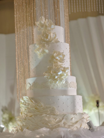 A large wedding cake with luxury decorations represents the splendor of the event for a happy coupleの写真素材