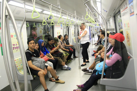 Singapore, Feb 25, 2015. The passengers, which are dominated by tourists, use the convenient public transportation service MRT (Mass Rapid Transit).のeditorial素材
