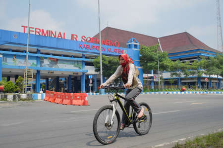 Klaten, Indonesia, March 3, 2021. Cyclists pass through the land transportation terminals of intercity and inter-provincial buses Ir. Soekarno.のeditorial素材