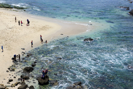 Jember, Indonesia, Sept 12, 2015. Local tourists visit Papuma Beach. Tanjung Papuma is a type of beach that has large waves as it faces directly to the Indian Ocean,のeditorial素材
