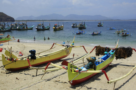 Jember, Indonesia, Sept 12, 2015. The boats anchored on Papuma beach after they sailed for fish with fishermen. Papuma Beach is one of the favorite tourist destinations in East Javaのeditorial素材