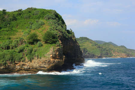 Clusters of cliffs on the towering beach of Gunungkidul meet with strong Indian Ocean wavesの写真素材