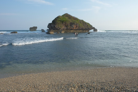 Ngandong Beach, Gunungkidul, Yogyakarta, with a coral island that blocks the waves from offshore makes the waters relatively calmの写真素材