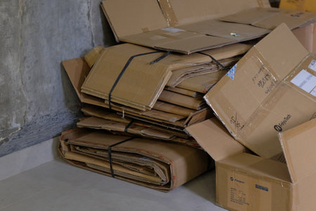 Yogyakarta, Indonesia, June 29, 2021. Used cardboard boxes for packing goods that are folded and tidied up before being sold to recycling services.のeditorial素材