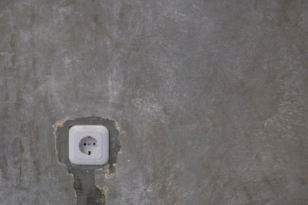 Electrical plugs embedded in industrial-style gray walls