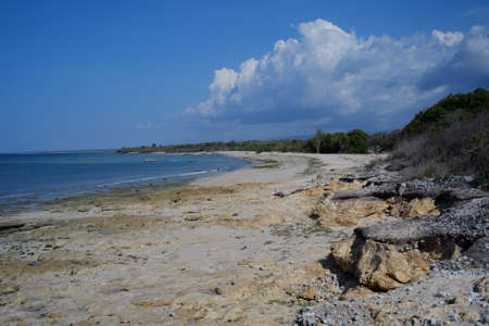 Blue sea, rocky beaches, blue skies are the perfect combination to spend a sunny day at Katewel beach clusters, Southwest Sumba, NTT, Indonesia.の写真素材