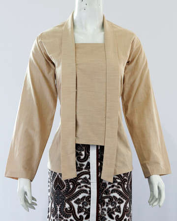 Women's light brown kebaya with plain patterns gives a graceful impression with a traditional taste but still fashionable.の写真素材