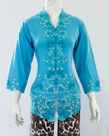 Women's shirt with half sleeves and beautiful brocade embellishments from the neck to the front. Oriental and Javanese ethnic style clothes, looks elegant when used in formal events.の写真素材
