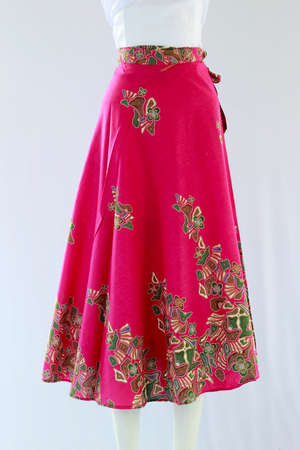 Women's pink wrapped batik skirt with ethnic motifs looks beautiful, simulated worn on a mannequin.の写真素材