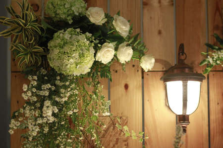Decorative lights and greenery against a brown plank background in a vintage-style decorの写真素材