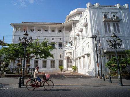 Semarang, Indonesia, Sep 19, 2020. A cyclist passes in front of the magnificent Jiwasraya insurance building in Kota Lamaのeditorial素材